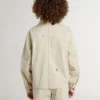 Beige Kinderjacke mit mehrfarbigen Spritzern