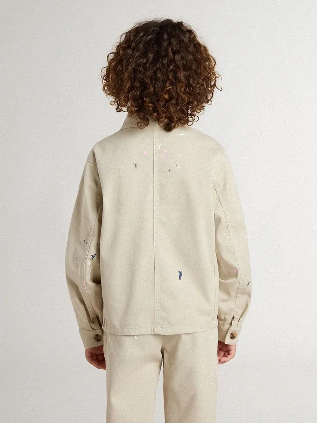 Beige Kinderjacke mit mehrfarbigen Spritzern