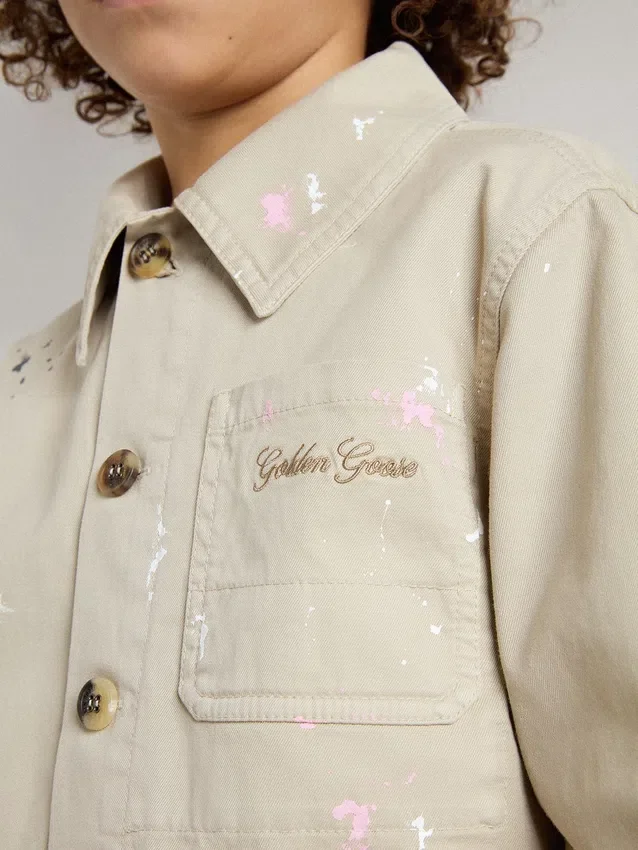Beige Kinderjacke mit mehrfarbigen Spritzern