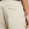 Beigefarbene Chino-Hose für Kinder mit bunten Farbtupfern