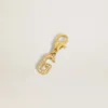 Buchstabe G als Anhänger aus goldfarbenem Messing mit Kristallen