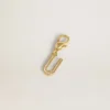 Buchstaben-U-Anhänger aus goldfarbenem Messing mit Kristallen