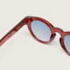 Cameron Panthos-Sonnenbrille mit honigfarbenem Rahmen, Edelsteinen und blauen Gläsern