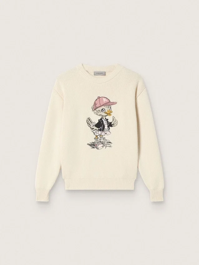 Goldfarbener Mädchenpullover aus weissem Baumwollgarn mit Maskottchen-Stickerei