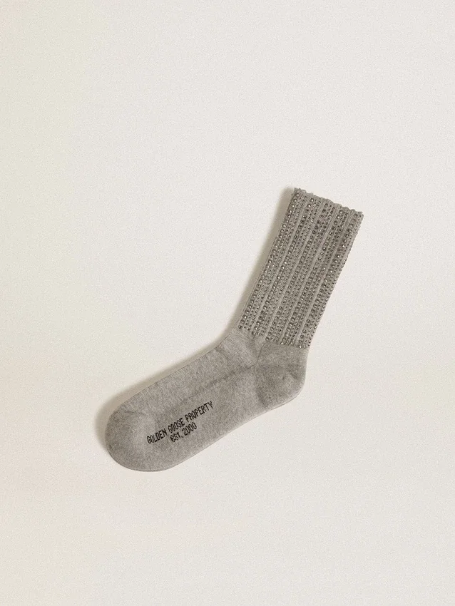 Graue Socken mit Kristallen am Bein