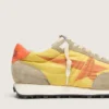 Herren-Marathon mit gelbem Nylon-Obermaterial und orangefarbenem Stern