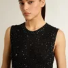 Schwarzes Mesh-Strickoberteil mit Pailletten und kontrastierenden Details