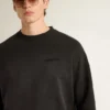 Unisex-Sweatshirt aus abgenutzter schwarzer Baumwolle mit gesticktem Logo
